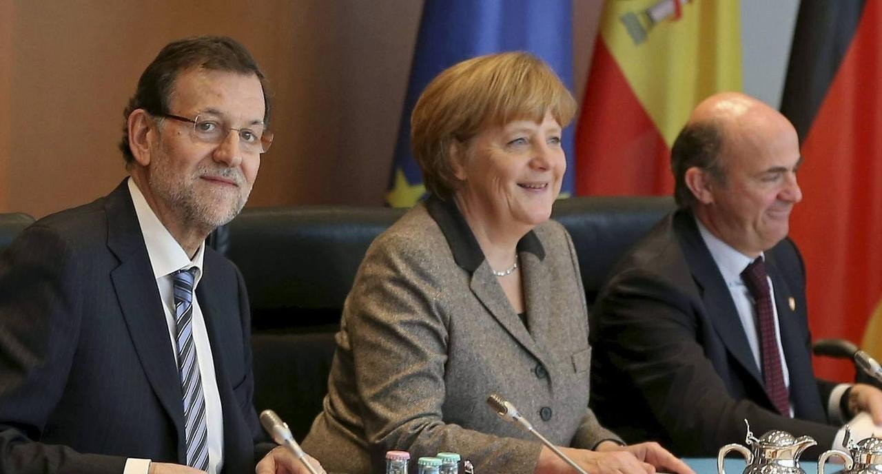 Rajoy, Merkel, y De Guindos.