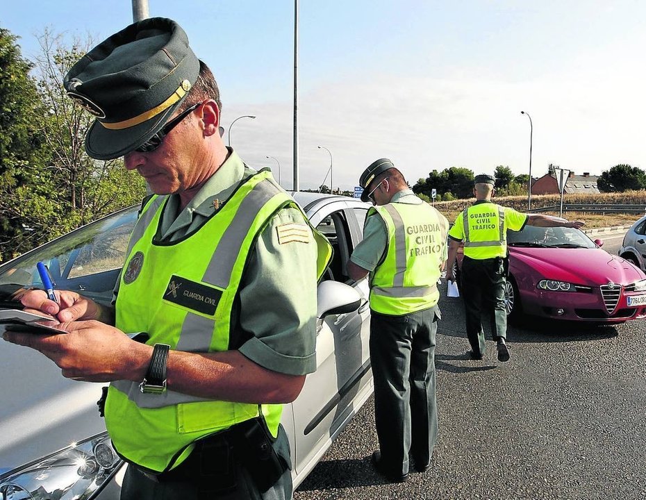 Un guardia civil multando a un conductor. 