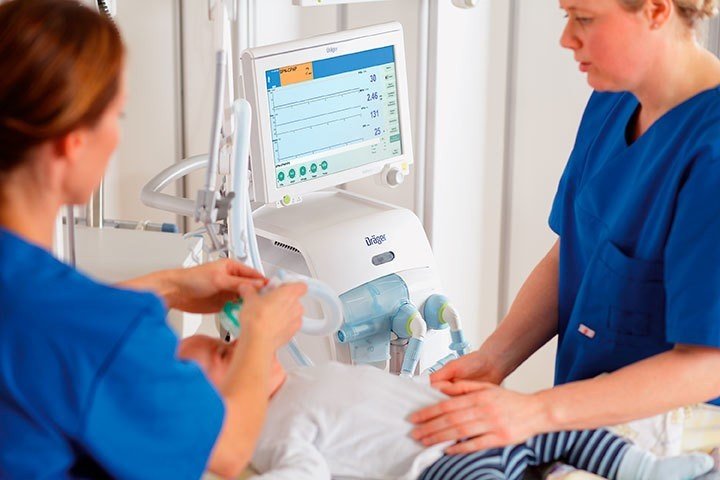 Enfermeras atendiendo a un bebé al que se le va a aplicar un respirador