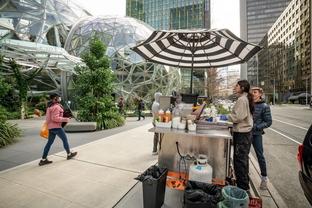 March 5, 2020 - Seattle, Washington, United States: The usual crowds of Amazon workers were nowhere to be seen during lunch today at Amazon's Seattle campus. Here Kim Garcia (right) of "Wonderbowl" loks for customers from her food stall next to Amazon's H