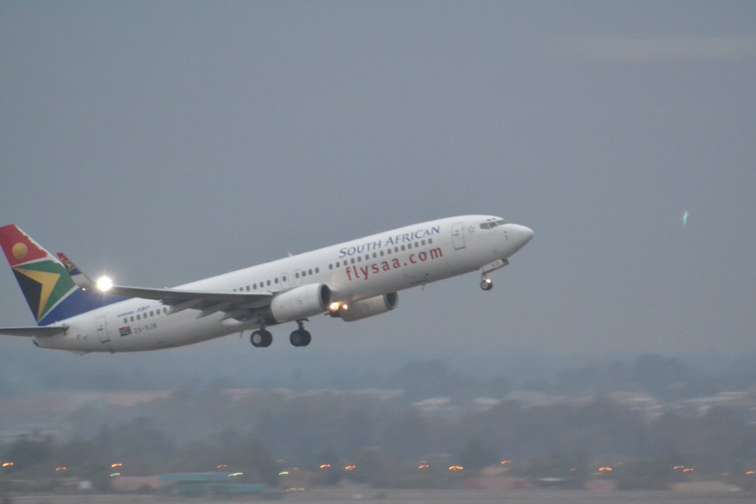 Compañía aérea sudafricana despegando de un aeropuerto.