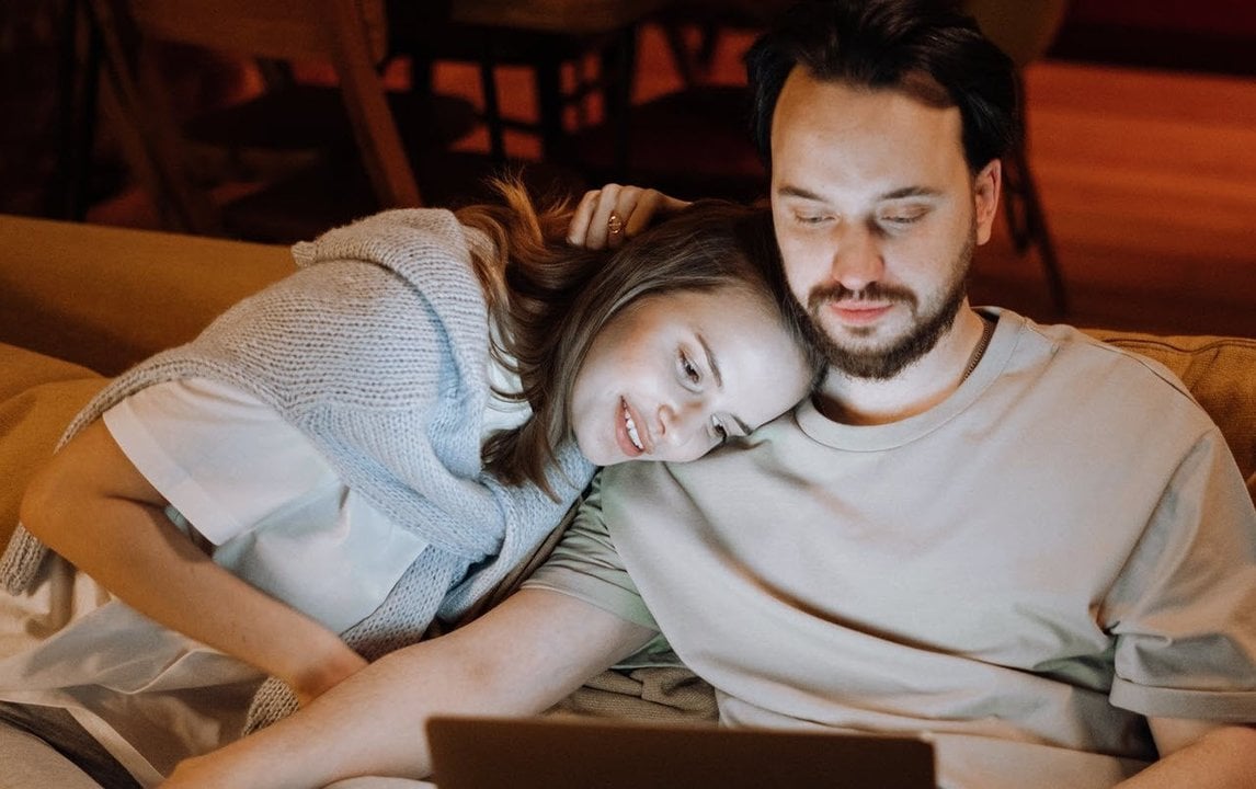 Dos personas mirando la pantalla de un ordenador portátil.
