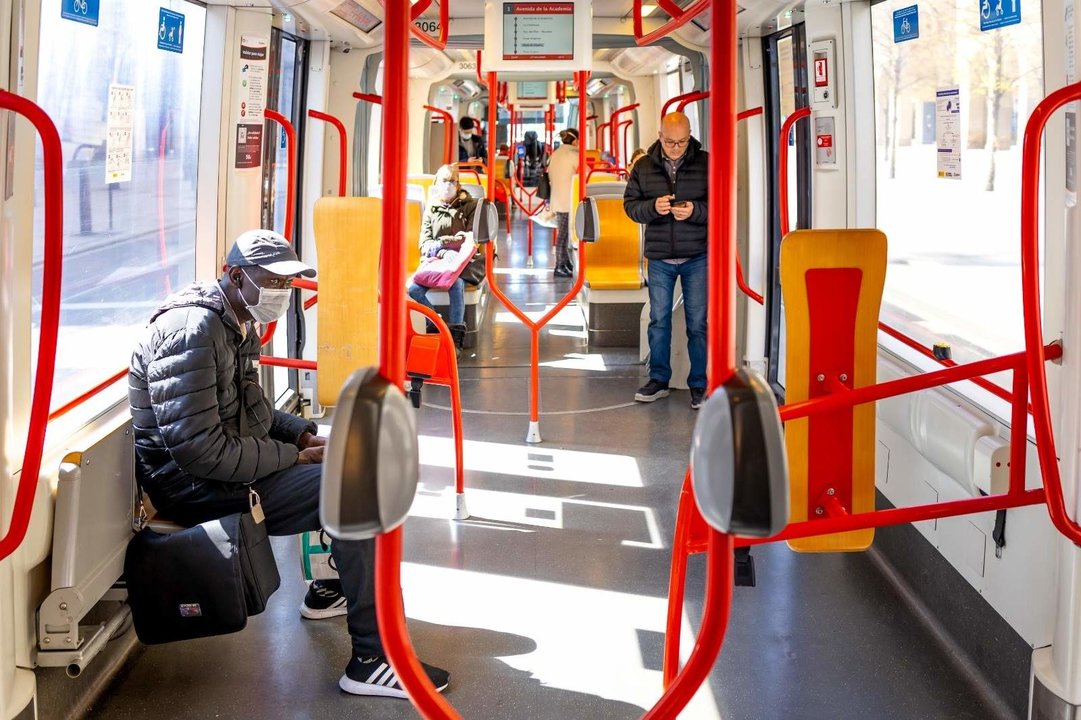 Interior de un autobús con viajeros que llevan mascarilla.