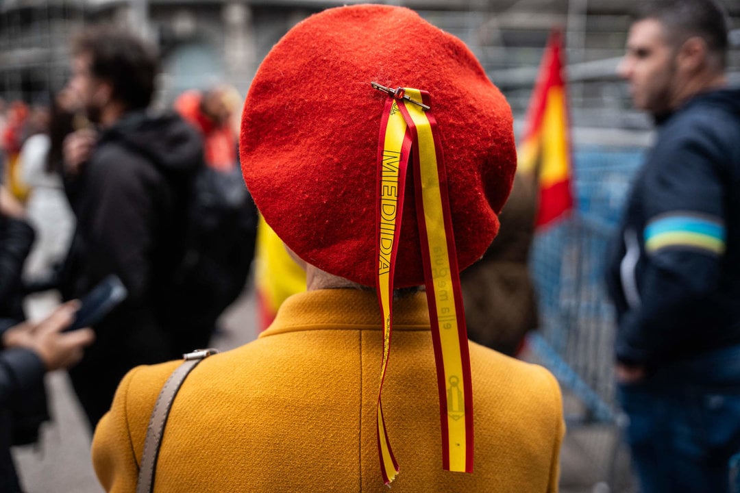 Una manifestante con la boina roja cerca del Congreso de los Diputados (Foto: Matias Chiofalo / Europa Press).