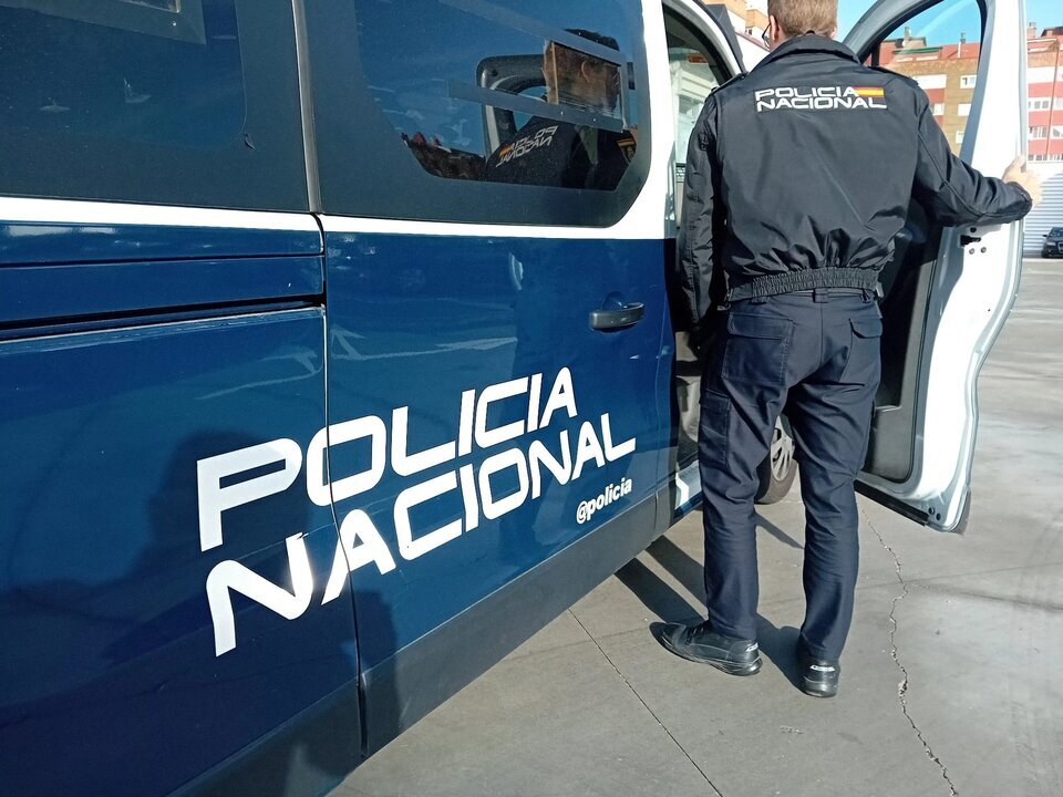 Archivo - Un agente y un coche de la Polic&iacute;a Nacional.