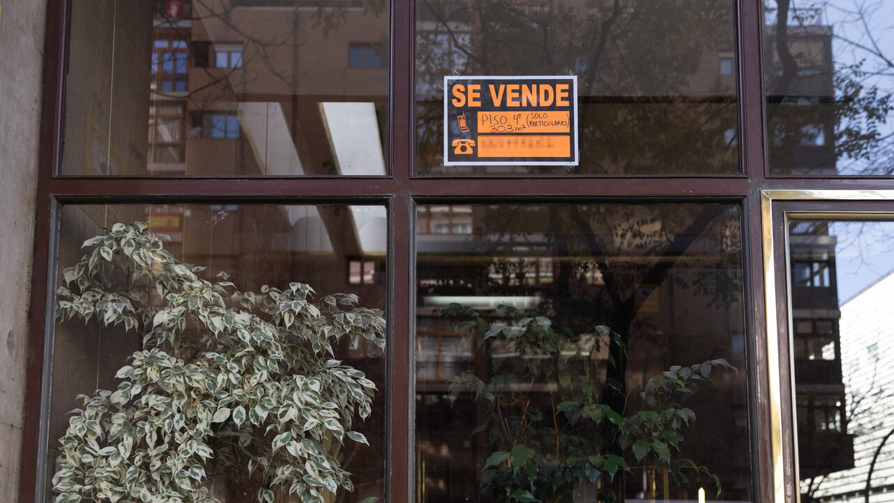 Un cartel de 'Se vende' en un portal de un edificio de viviendas.