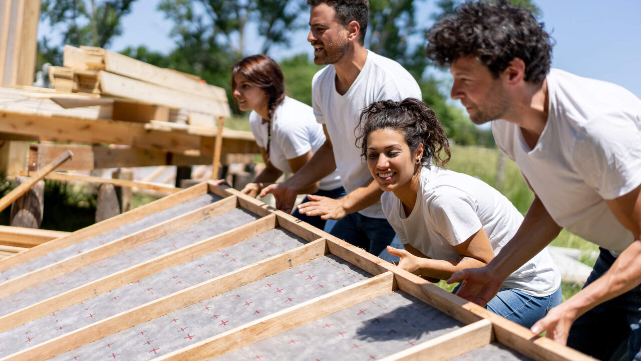 Latin american volunteers working hard at a charity construction project - Charity and relief concepts