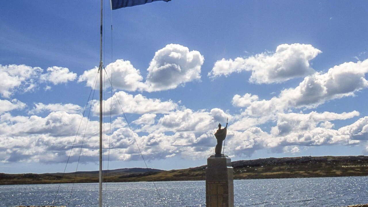 Falkland Islands flag flies over memorial monument in Port Stanley, capital of the Falkland Islands, erected by the islanders to commemorate their liberation in the brief undeclared war between Argentina and Great Britain in 1982 over control of the Falkland Islands (Islas Malvinas).