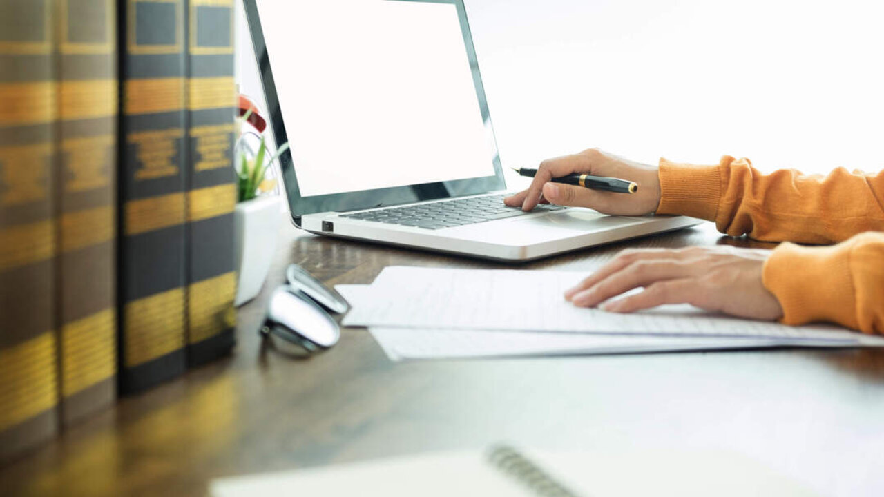 Attractive Young beautiful entrepreneur Woman smiling and looking at laptop screen, Working from Home