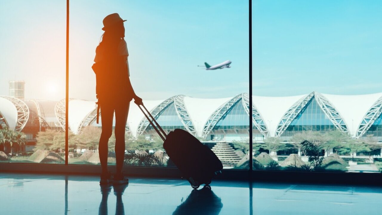 Silhouette woman travel with luggage looking without window at airport terminal international or girl teenager traveling in vacation summer relaxation holding suitcase and backpack