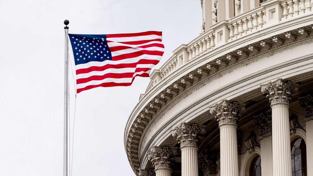 March 31, 2022 - Washington, DC, United States: American flag flying above the U.S. Capitol.