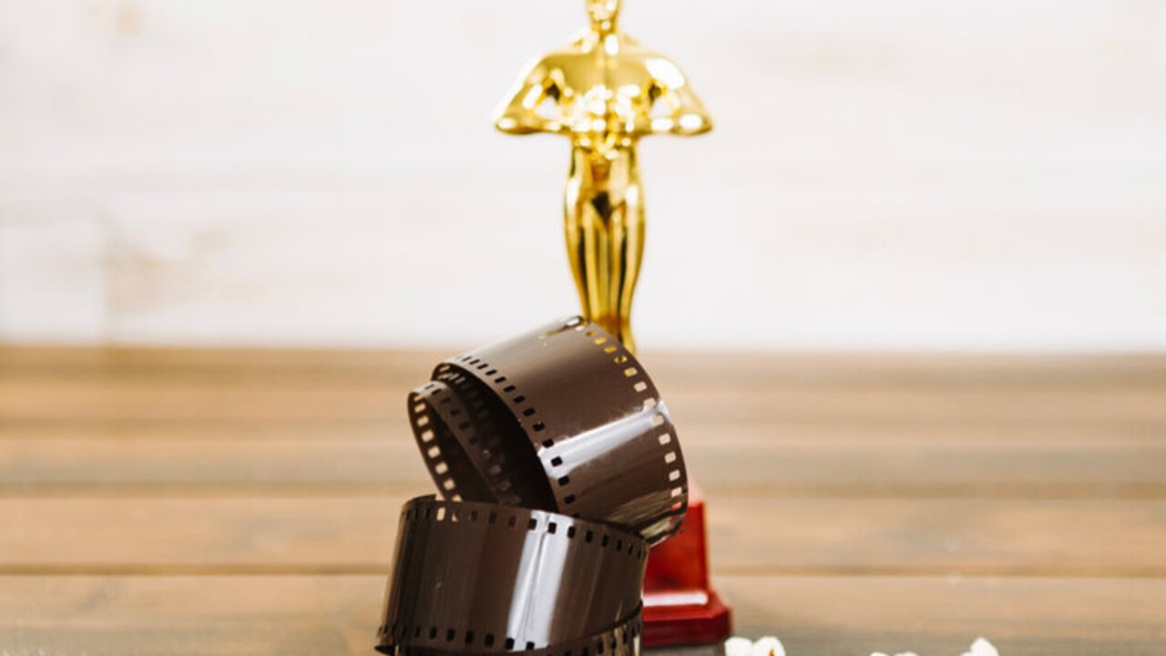 pelicula-enrollada-palomitas-de-maiz-y-estatuilla-de-oscar