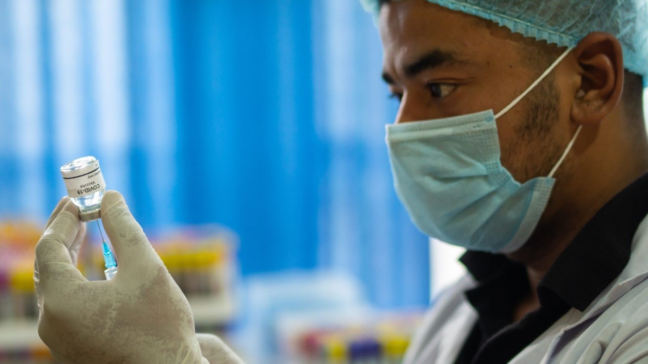 Un médico manipulando una vacuna del coronavirus