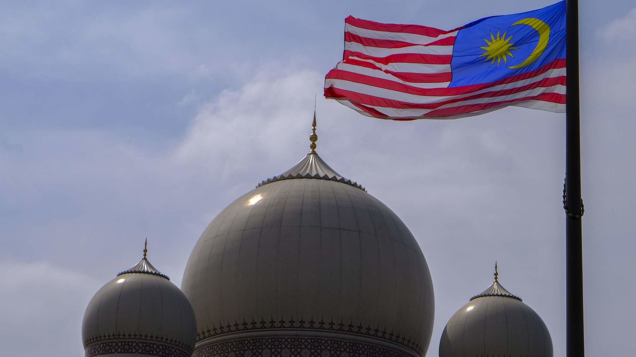 Malaysia flag seen on the top of Palace of Justice building's dome at the 61st Malaysia anniversary of independence day at Dataran Putrajaya...Malaysians celebrated 61st anniversary of the nation's independence day on every 31st August. The Prime Minister of Malaysia, Dr. Mahathir Mohamad had chosen Putrajaya the nation’s administrative capital as a venue for the celebration.  This year’s slogan will be ‘Sayangi MalaysiaKu’ which means ‘Love My Malaysia’.