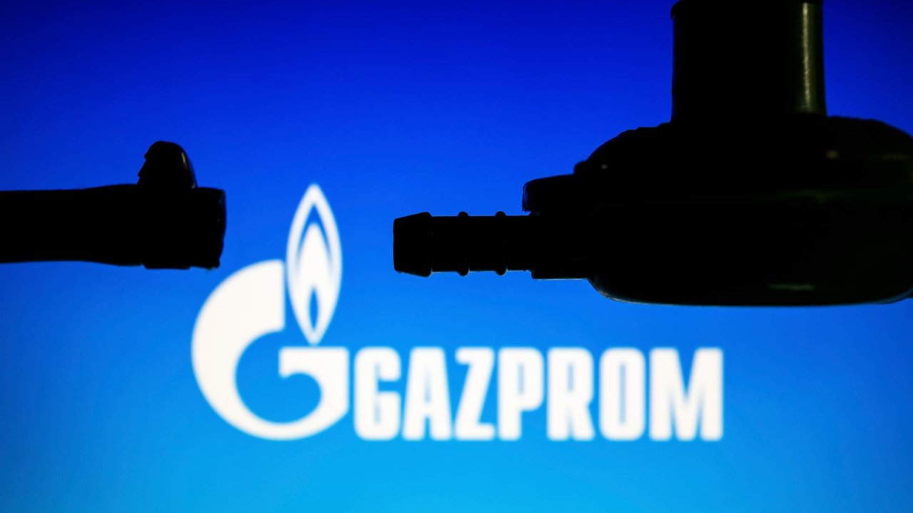 Illustration photo shows a disconnected hose and LPG gas pressure regulator backdropped by displayed logo of Gazprom, a Russian state-owned energy company.