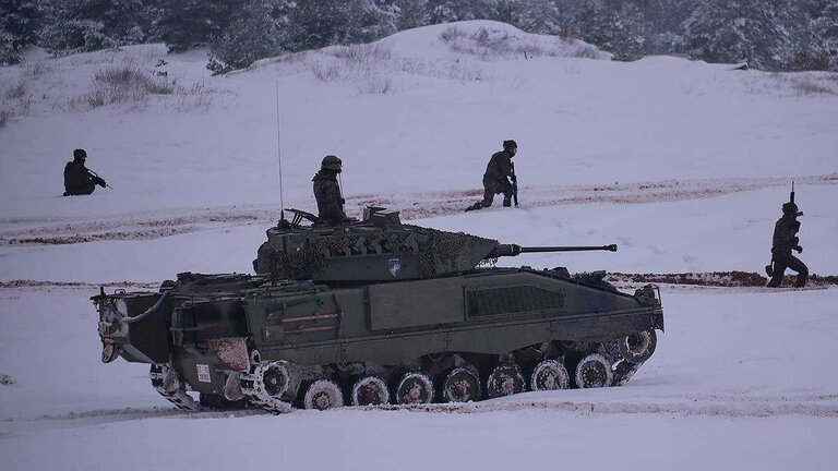 Militares espa&ntilde;oles con un veh&iacute;culo Pizarro del Ej&eacute;rcito de Tierra, en Letonia (Foto: Sgt.1&ordm; Jes&uacute;s Aguilera, eFP BG Latvia).