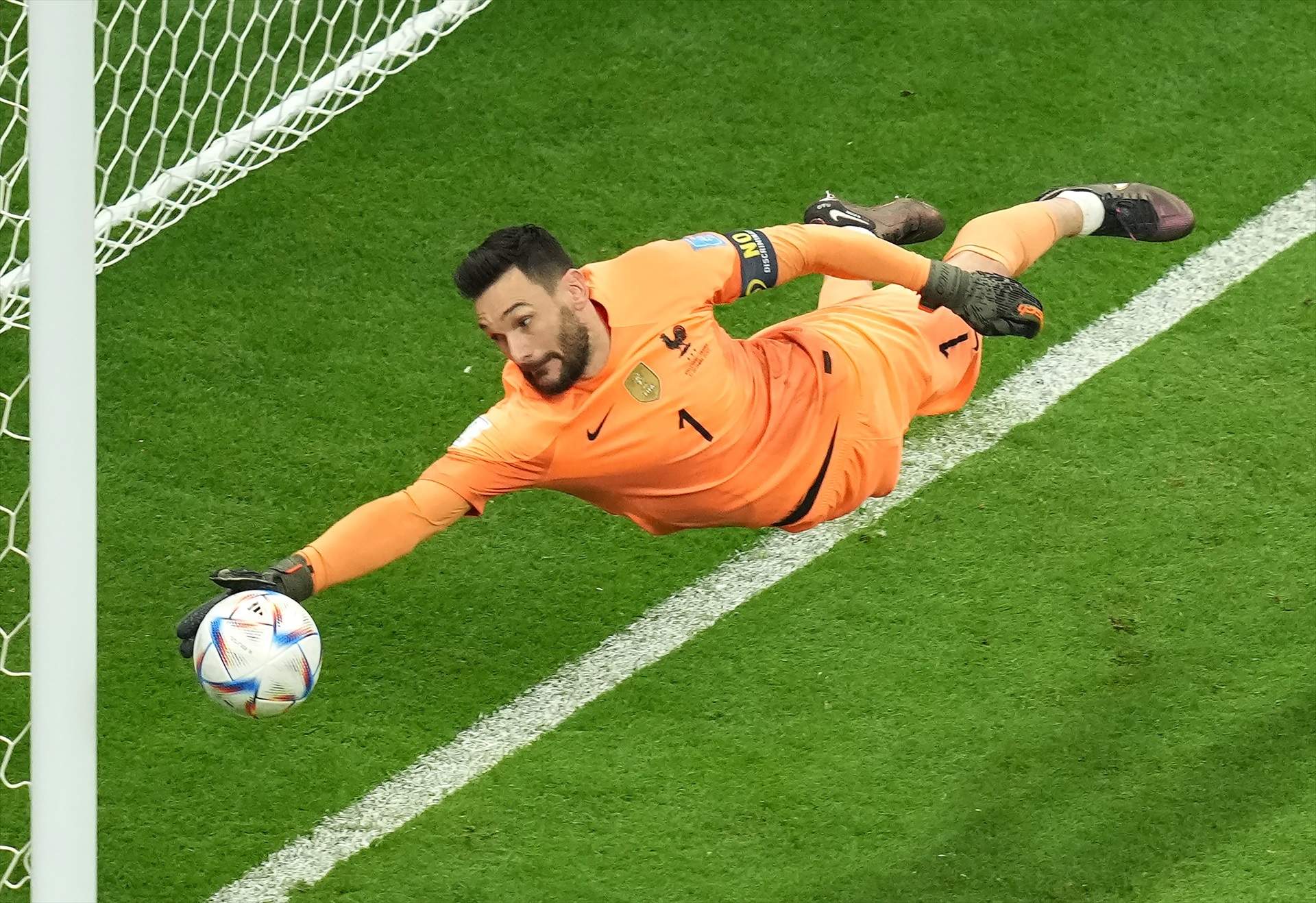 10 December 2022, Qatar, Al Khor: France goalkeeper Hugo Lloris saves a shot from England's Harry Maguire during the FIFA World Cup Qatar 2022 Quarter-Final soccer match between England and France at the Al Bayt Stadium. Photo: Peter Byrne/PA Wire/dpa