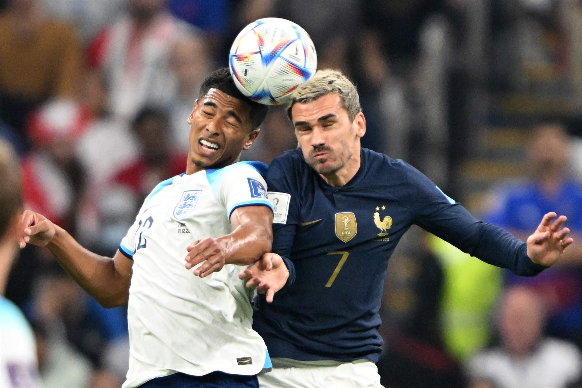 10 December 2022, Qatar, Al Khor: England's Jude Bellingham (L) and France's Antoine Griezmann battle for the ball during the FIFA World Cup Qatar 2022 Quarter-Final soccer match between England and France at the Al Bayt Stadium. Photo: Robert Michael/dpa